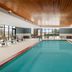 Home2 Suites by Hilton Alexandria indoor pool with lounge chairs and large windows in Alexandria
