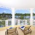 Bahia Principe Luxury Bouganville in La Romana balcony with lounge chairs and tropical resort and ocean view