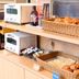 Breakfast buffet at Comfort Hotel Narita in Narita with bread baskets, toaster, and condiments