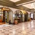 The Reserve at Park MGM in Las Vegas lobby corridor with arched storefronts and marble tile floor