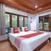 OYO 75353 Loy Chalet Resort room in Nakhon Si Thammarat with bed and large windows