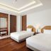 The Ubufuru Ishigaki bedroom in Ishigaki with two twin beds and wood flooring