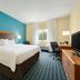 Fairfield Inn by Marriott Kankakee Bourbonnais guest room with king bed, desk, TV and window in Bourbonnais