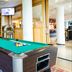 Bastion Hotel Barendrecht game room with pool table, red chair, and bookshelves in Barendrecht