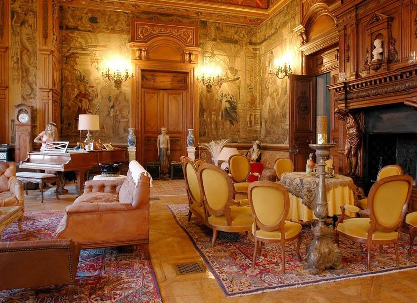 B&B Chateau de Villersexel in Villersexel: ornate salon with fireplace, piano, and antique seating