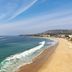 Pacific Edge Hotel in Laguna Beach overlooking a wide sandy beach and ocean waves