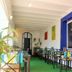 La Caleta de Tamariu in Tamariu: colorful dining area with blue-trimmed window and green floor