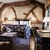 The White Swan Hotel in Stratford-upon-Avon: rustic four-poster bed with exposed beams and sitting area