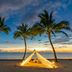 Le Méridien Khao Lak Resort & Spa beach cabana between palm trees at sunset in Khao Lak