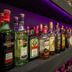 Balis Best Bar and Resort Nairobi bar shelves lined with assorted liquor bottles and purple accent lighting