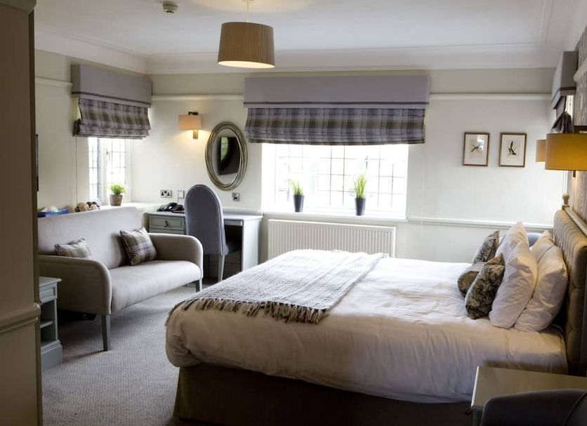 The Broadoak in Ashton-under-Lyne guest room with double bed, armchair, desk and window seating