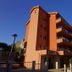Hotel Stella di Mare in Bečići, orange beachfront hotel exterior with balconies under a blue sky