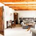 Casa Blanca Hotel in Windhoek: bright lounge with exposed wooden beams, sofas, desk and arched windows