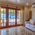 The Colonial at Jaguar Reef in Hopkins: bright living room with sofa and French doors to pool area