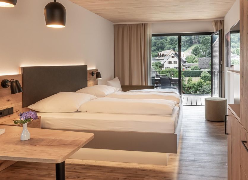 Goldener Adler Oberried guest room with twin beds and balcony view to the mountains
