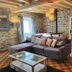 Le Clos Loret in Saint-Germain-du-Corbéis: rustic lounge with stone walls, sectional sofa and glass coffee table