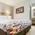 Red Roof Inn Detroit - Farmington Hills guest room with king bed and bedside table