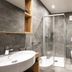 Hotel Lener, Mauls: modern bathroom with glass shower, wall-mounted toilet, sink and towel radiator