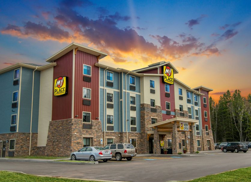 My Place Hotel-Marquette, MI exterior at sunset in Marquette with parking lot and colorful sky