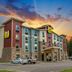 My Place Hotel-Marquette, MI exterior at sunset in Marquette with parking lot and colorful sky