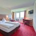 Rothenfels Panorama Hotel room in Immenstadt im Allgäu with double bed, desk, and balcony doors