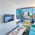 Aura on Flinders Serviced Apartments Melbourne living room with city skyline and balcony view