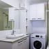 River Sands Apartments Maroochydore bathroom with vanity, mirror, washer and shower-over-bathtub