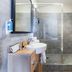 Appart'City Classic Reims Parc des Expositions bathroom with walk-in shower, sink and towel radiator