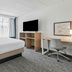 Spark by Hilton Mechanicsburg Harrisburg West room with bed, desk, TV and window in Mechanicsburg