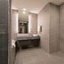 Airsky Hotel Incheon bathroom with large mirror, stone vanity, and modern toilet in Incheon