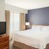 Residence Inn by Marriott New Bedford Dartmouth guest room with king bed, bedside lamps and window