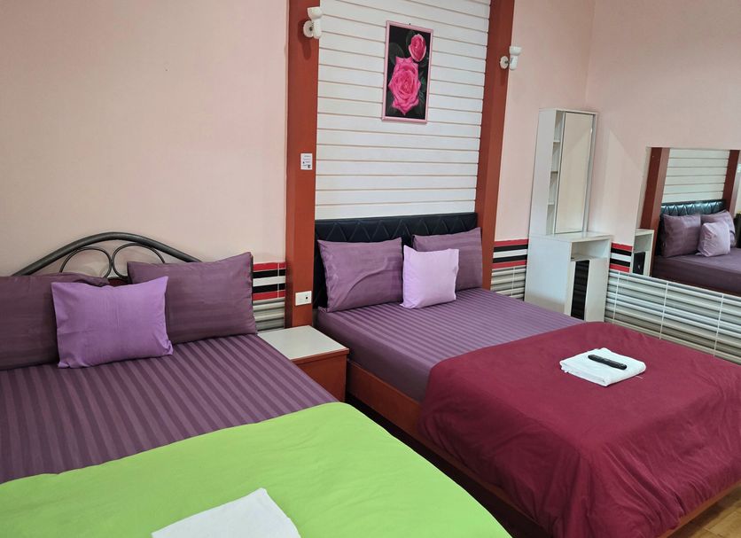 Khiangle Resort 1 in Songkhla room with two beds, striped bedding, and wall mirror