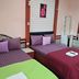 Khiangle Resort 1 in Songkhla room with two beds, striped bedding, and wall mirror