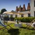 Kurort Stara Wedzarnia in Gdansk features a sunny garden patio with lounge chairs and umbrellas
