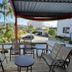 Hotel Arco Do Sol terrace seating with palm trees and city view in Balneário Camboriú
