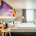 Four Points by Sheraton Offenbach Plaza room with twin beds, colorful wall art and window seating