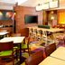 Fairfield Inn & Suites Parsippany breakfast area with tables, chairs, bar seating and colorful carpet