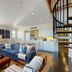 The Nantucket Hotel & Resort living room with blue sofas, spiral staircase, and open kitchen on Nantucket