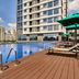 Oakwood Residence Saigon in Ho Chi Minh City with rooftop pool, sun loungers and city views
