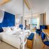 Minos Imperial Luxury Beach Resort & Spa Milatos bedroom with blue accents and balcony view