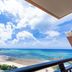 Kafuu Resort Fuchaku Condo Hotel in Onna with balcony view of beach, turquoise sea and cloudy sky