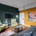 The Oxford at Pike Place Market in Seattle living area with sofa, chairs, wall TV and colorful artwork