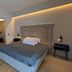 Hotel garni Santa Caterina in Orta San Giulio bedroom with king bed, warm lighting and wood floor