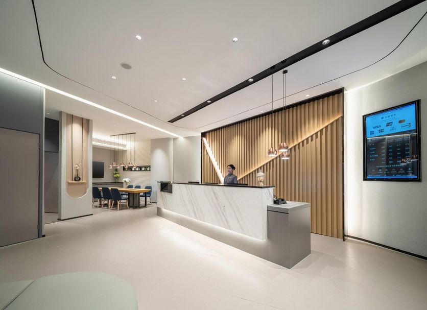 Home Inn Neo Zhuhai Gongbei Port Light Rail Terminal lobby with modern reception desk and seating area