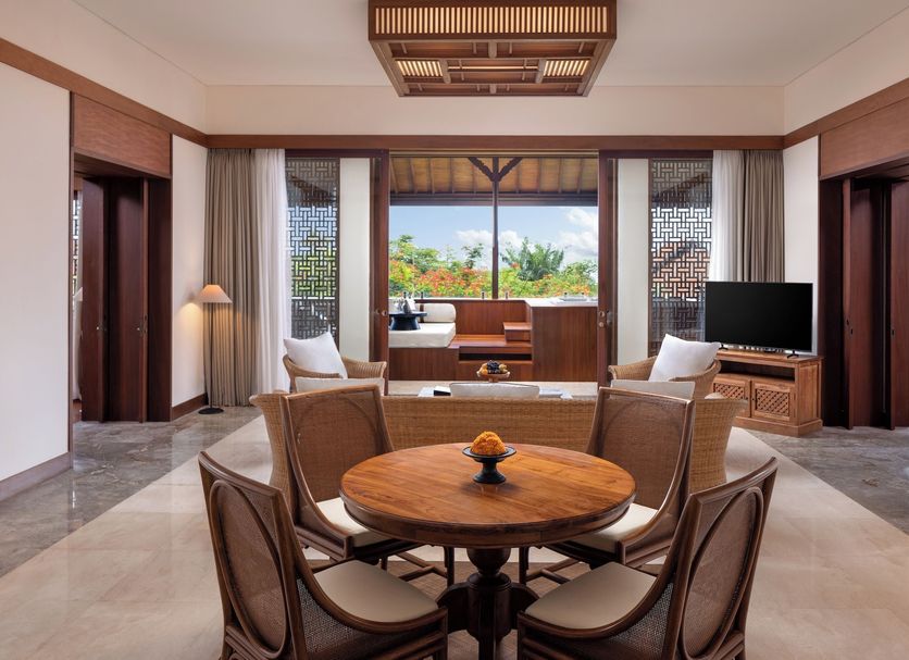 Sadara Resort, South Kuta: spacious suite with round dining table, TV, and balcony garden view