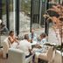 Guests seated around a table in Vann Spa Hotell & Konferens lounge, Brastad, beside floor-to-ceiling windows