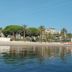 Hôtel Cecil in Antibes with beachfront view, palm trees, sandy shore and calm sea reflections