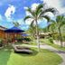 Magic Oceans Dive Resort in Anda with tropical bungalows, lounge chairs, palm trees and garden path