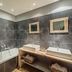 Hôtel La Suite bathroom in Villeneuve-lès-Avignon with bathtub, double sinks and tiled walls