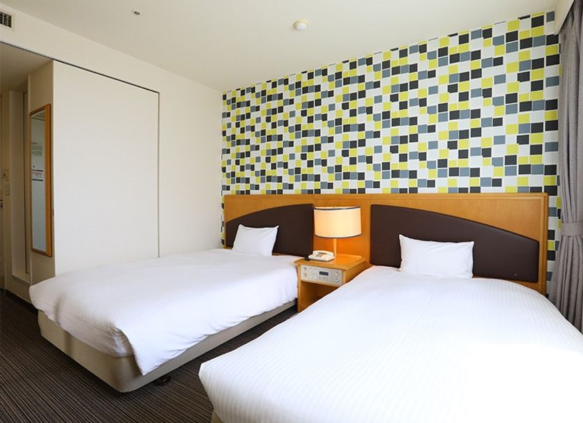 Koko Hotel Tomakomai in Tomakomai twin guest room with patterned accent wall